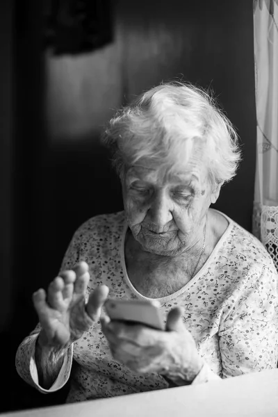 Elderly Woman Sits Smartphone Her Hands Soft Black White Photo — Stock Photo, Image