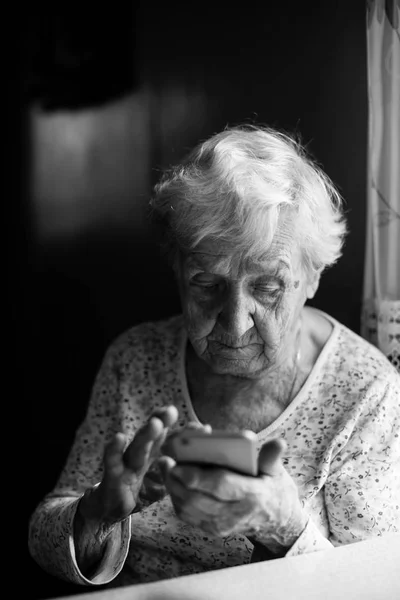 Elderly Woman Sits Smartphone Her Hands — Stock Photo, Image