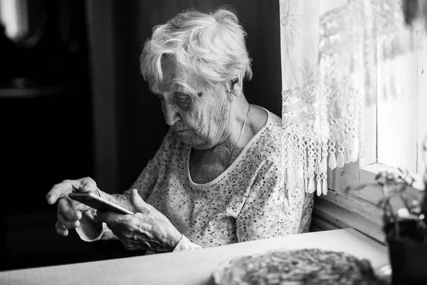 Elderly Woman Sits Smartphone Her Hands — Stock Photo, Image