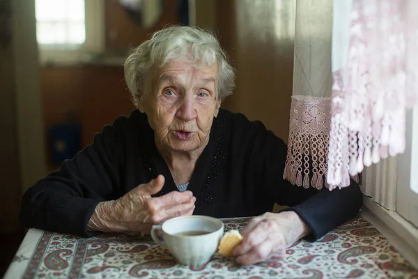 Elderly Woman Drinking Tea Cookies Home — 스톡 사진