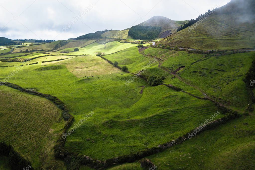 Flying over green fields of San Miguel island on Azores, Portugal.