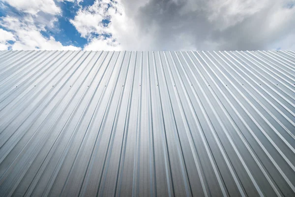 Metal sheet wall against blue sky — Stock Photo, Image