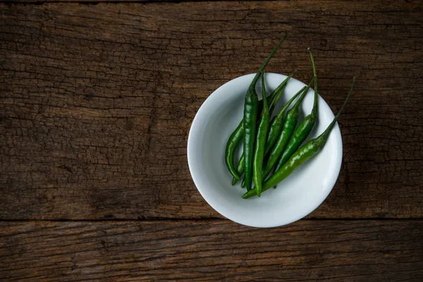 Hot chili peppers on a wooden board — Stock Photo, Image