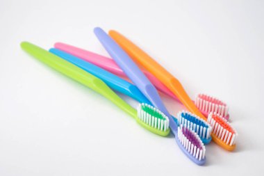 Beyaz arkaplanda renkli diş fırçaları
