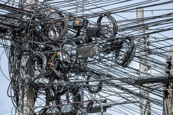 Stökigt elektriska kablar på inlägg — Stockfoto