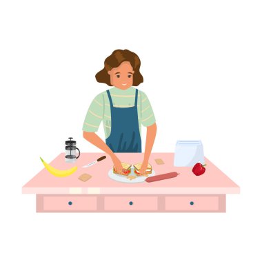 Önlüklü bir kadın lezzetli sandviçler yapıyor.