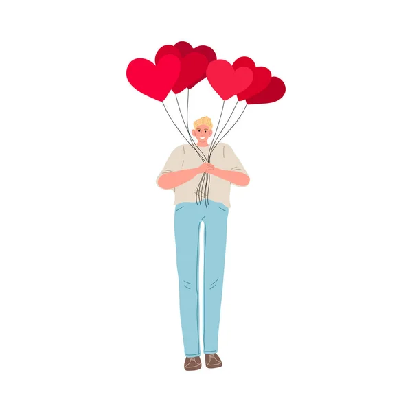 Young man standing, holding heap of heart shaped balloons in hands and expressing love — Stock Vector