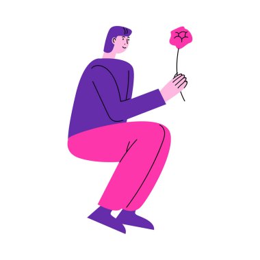 Oturan ve kız arkadaşına pembe çiçek veren bir adam.