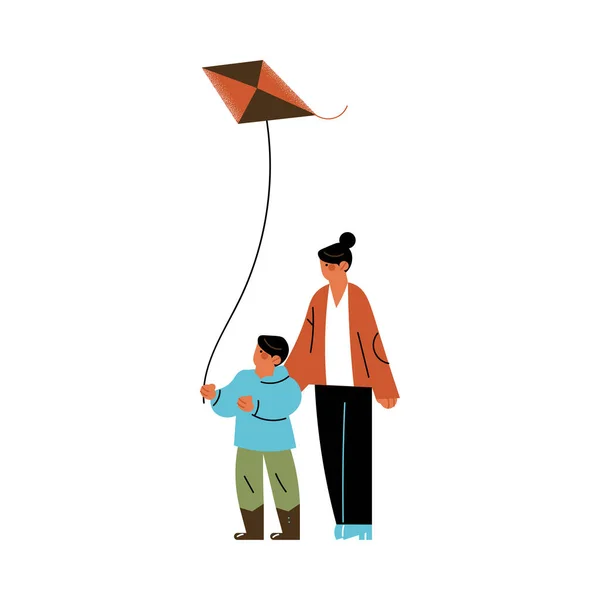 Glückliche junge Frau mit Sohn und fliegendem Drachen im Freien — Stockvektor