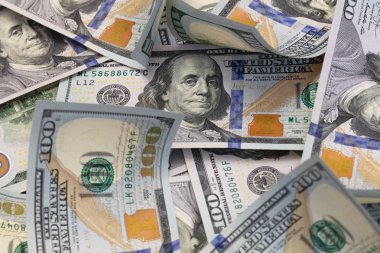 randomly layed 100 dollar bills background