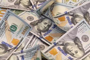 randomly layed 100 dollar bills background