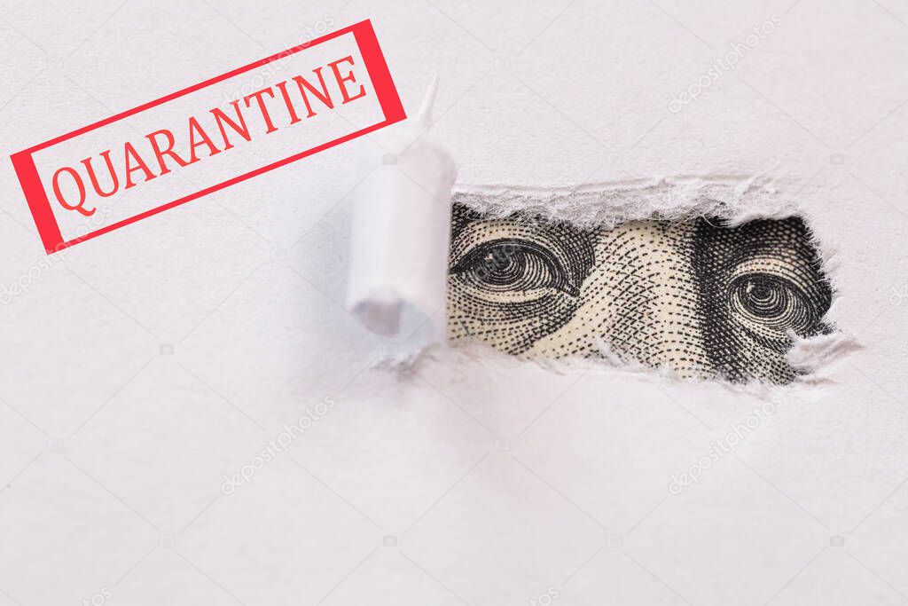 Red Quarantine sign on Benjamin Franklin macro peeking through torn white paper