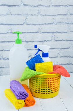 Spring cleaning concept, supplies and tools for cleaning and spring flowers. Liquid disinfectants, sponges and cleaning cloths. Copy space
