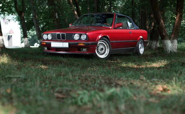 Red cabriolet in park — Stock Photo, Image