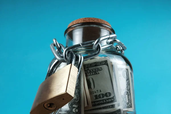 Jar full of money with big lock, keep your wealth in the safe place
