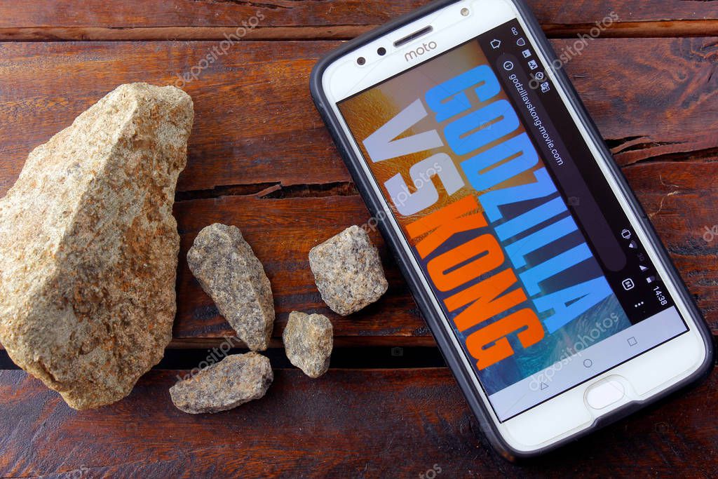 Rio de Janeiro, Brazil - February 10, 2020: Godzilla vs. Kong movie logo on the Moto G5s Plus phone screen. It's a future American monster duel movie