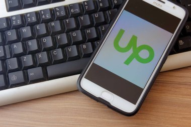 Rio de Janeiro, Brazil - February 14, 2020: Logo Upwork on the smartphone screen Moto G5s Plus. It is a global freelancing platform where companies and professionals connect.