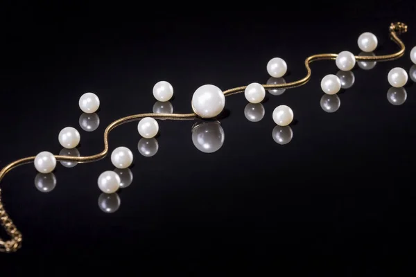 White pearls necklace on black background — Stock Photo, Image