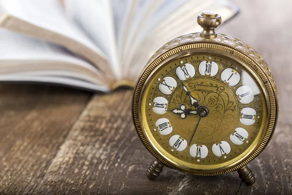 Holy Bible and alarm clock on wood table — Stock Photo, Image