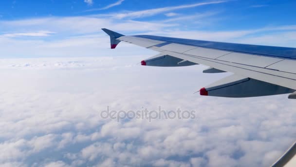 Wing of an airplane flying above the clouds — Stock Video