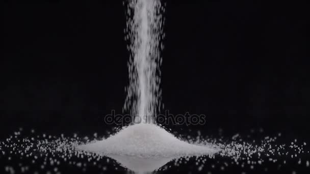 White sugar poured on black background — Stock Video