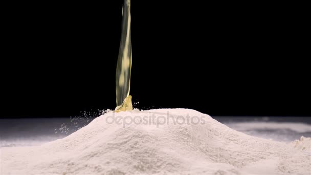 Raw egg falling in flour on black background — Stock Video