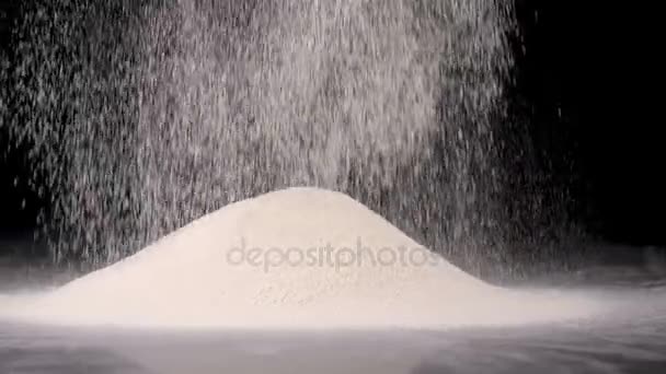 Pouring white flour on black table — Stock Video