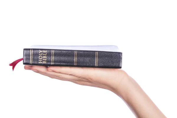 Ženská ruka drží Holy Bible na bílém pozadí — Stock fotografie