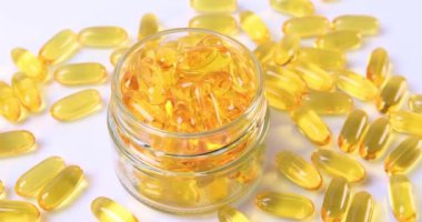Omega fish oil softgels dietary supplement in jar. Healthy life and heart health concept. Dolly shot 4k