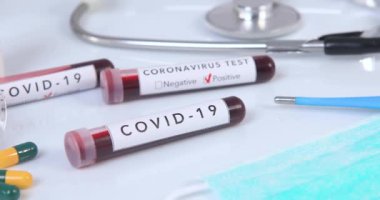 Yakın çekim kamera, virüs testi ve araştırması için Coronavirus hastalığı olan bir kan test tüpünün etrafında dönüyor. Dolly 4K çekti.