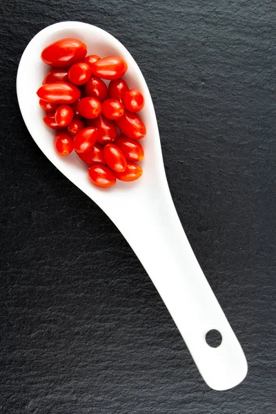 Fresh goji berries in a white porcelain spoon — Stock Photo, Image