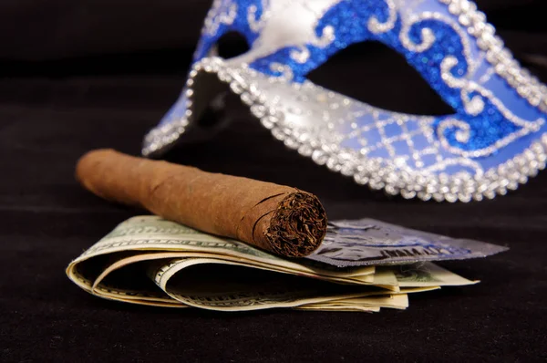 Prostitution concept: luxury cigar, money, condoms and seduction