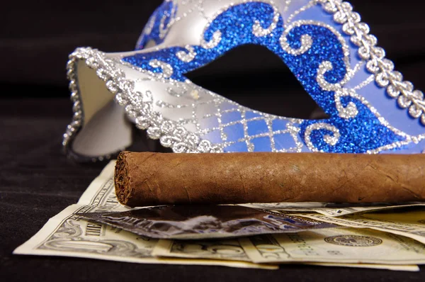 Prostitution concept: luxury cigar, money, condoms and seduction