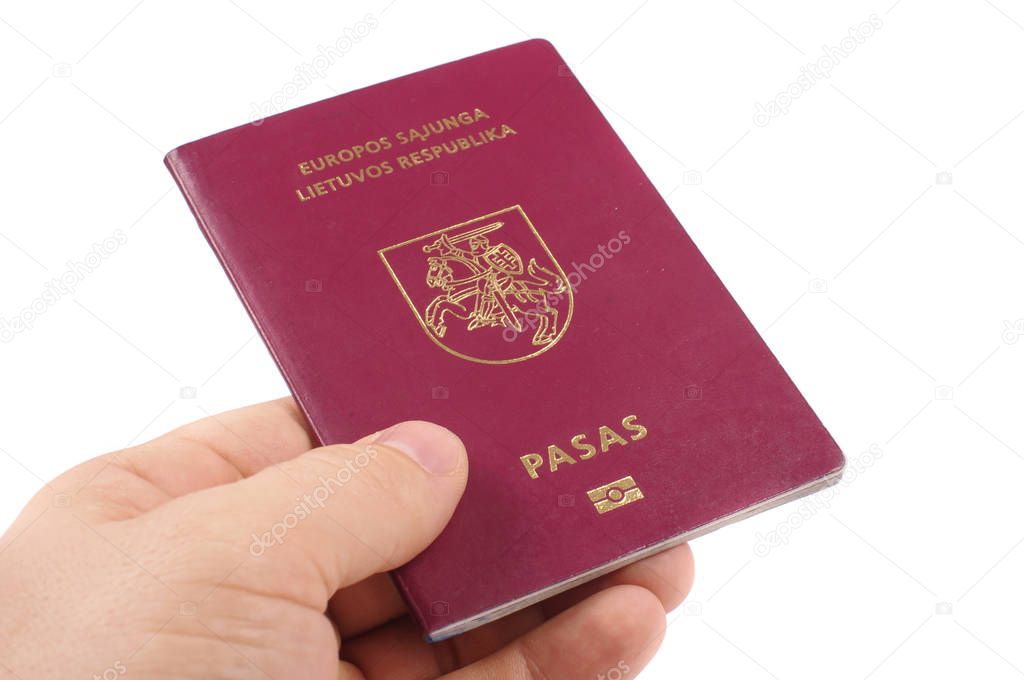 Male hand holding lithuanian passport