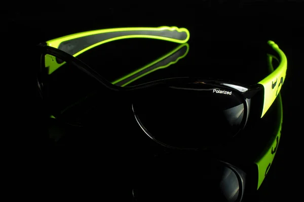 Stylish sunglasses isolated on the dark background — Stock Photo, Image