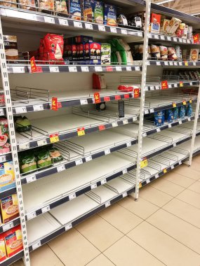 KAUNAS, LITHUANIA - FEBRUARY 29, 2020: Empty shelves in a Maxima supermarket. Shortages of products and oats supplies during panic of Corona virus.