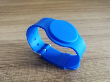 Radio frequency identification RFID tag integrated in wristband for hotels clipart