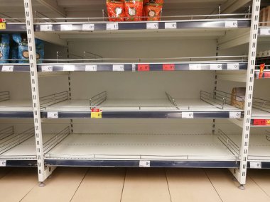 KAUNAS, LITHUANIA - FEBRUARY 29, 2020: Empty shelves in a Maxima supermarket. Shortages of products and oats supplies during panic of Corona virus.