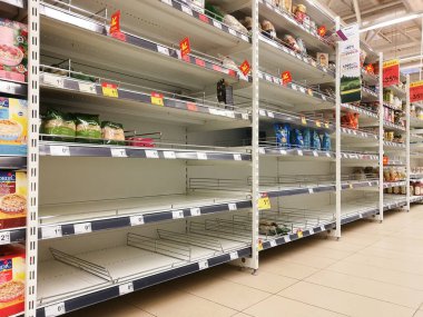 KAUNAS, LITHUANIA - FEBRUARY 29, 2020: Empty shelves in a Maxima supermarket. Shortages of products and oats supplies during panic of Corona virus.
