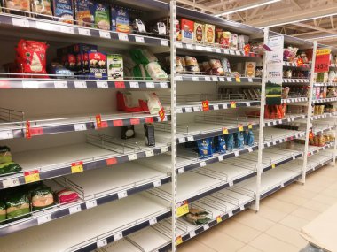 KAUNAS, LITHUANIA - FEBRUARY 29, 2020: Empty shelves in a Maxima supermarket. Shortages of products and oats supplies during panic of Corona virus.