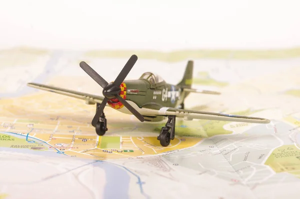 Old World War II model plane placed on the city map