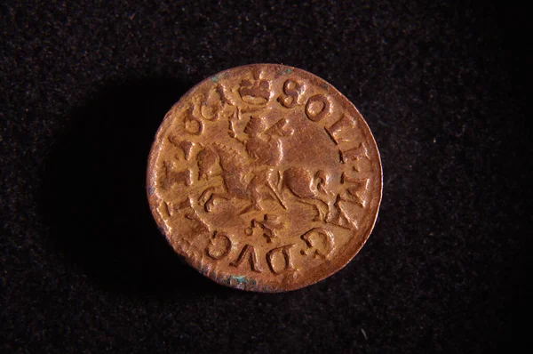 Old Grand Duchy of Lithuania copper coin shilling (silingas) isolated on the black background