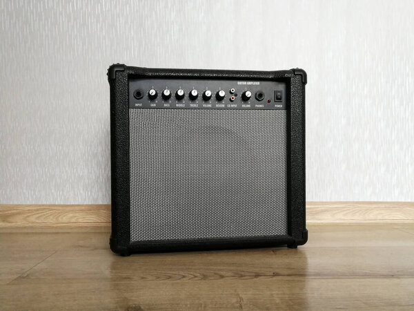 Combo amplifier and sound speaker for guitar on the wooden floor