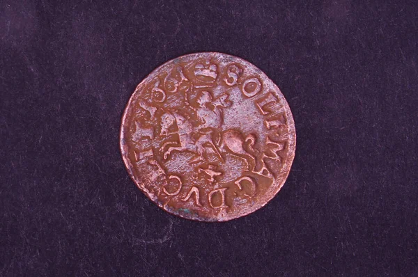 Old Grand Duchy of Lithuania copper coin shilling (silingas) isolated on the black background