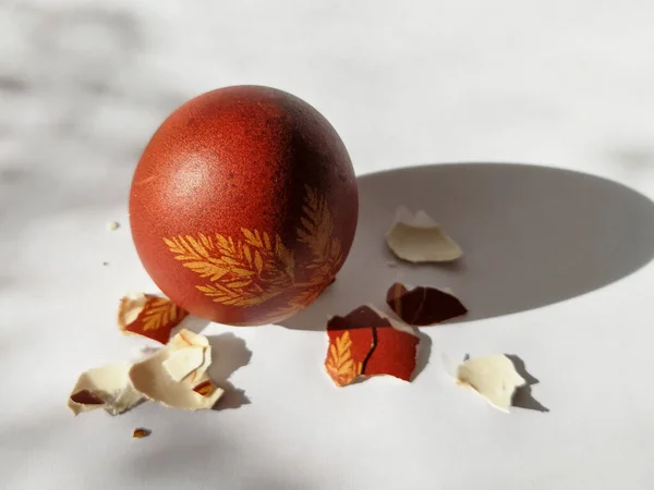 Broken eggshell painted Easter egg isolated on the white background