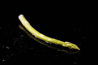 Siyah zemin üzerinde taze organik yeşil kuşkonmaz (asparagus officinalis) izole edilmiştir.