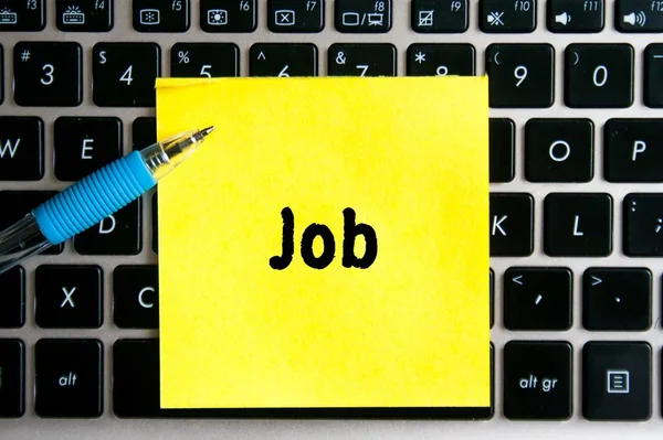 电脑键盘背景上的一张黄色贴纸上的题字 Job — 图库照片