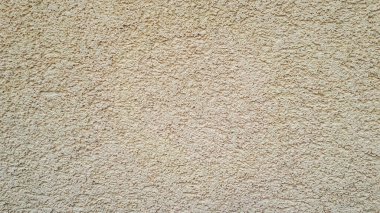 Duvarda güzel desenli alçı var. Sarı yeşil soyut arkaplan. Güzel sarı desenli sıva duvarda..