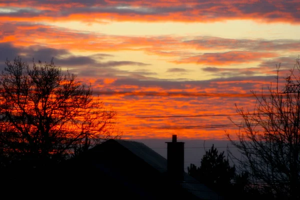 Red sky during sunset. Sunset over the home. Dramatic sky, Amazing red clouds.