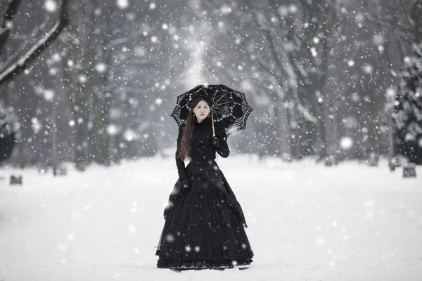 Siyahlı kadın Kraliçe Viktorya dönemine ait giysi kış parkta — Stok fotoğraf